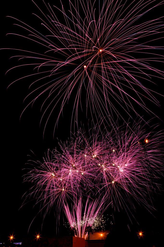 pink fireworks against a nighttime background
